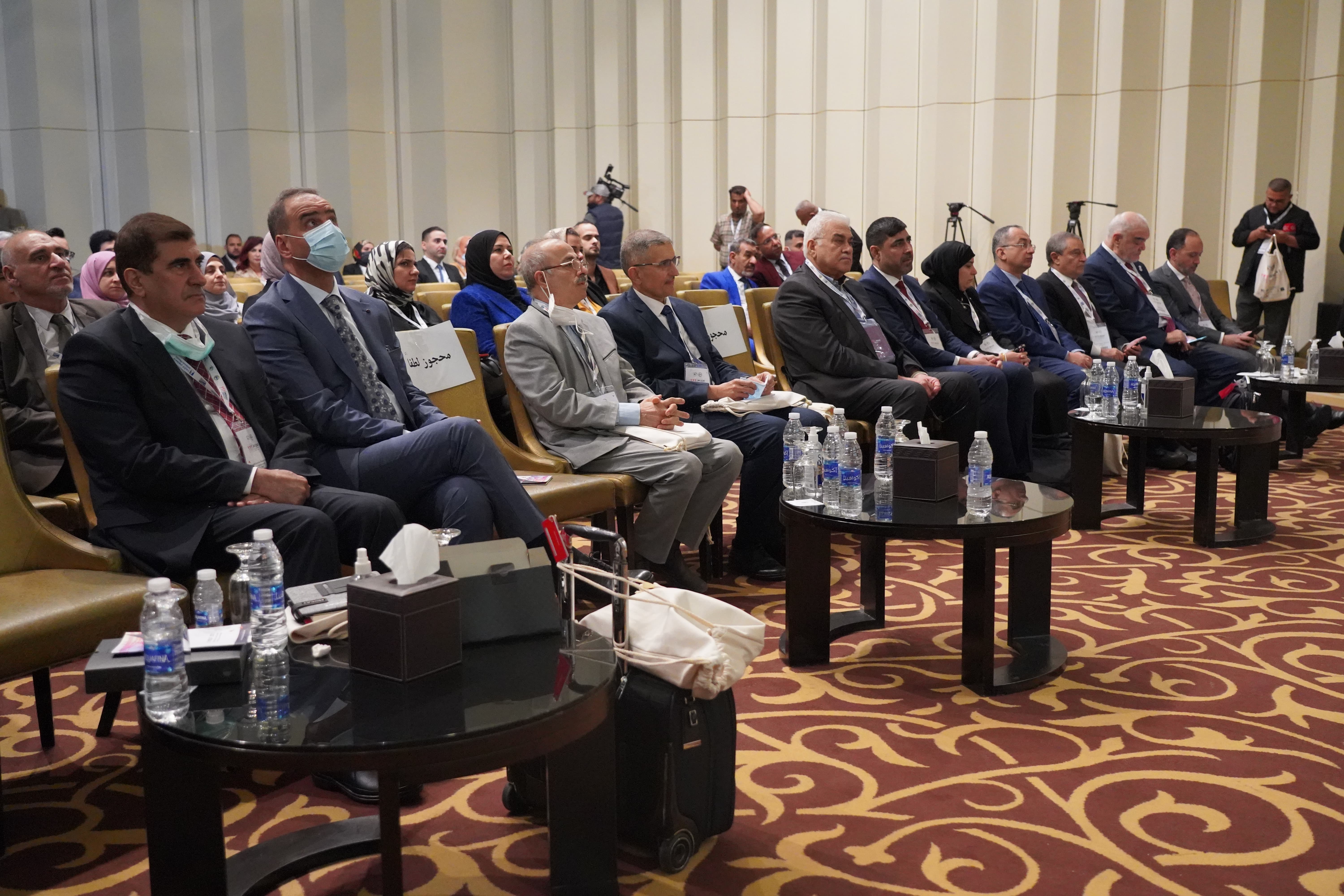 Conference attendees seated in formal meeting room during MOCAT 1
